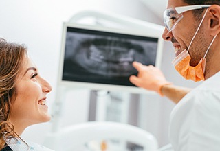 Patient and dentist looking at digital x-rays